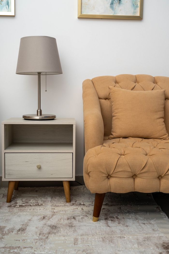 Stylish living room interior with sofa, lamp, and side table for a cozy home ambiance.